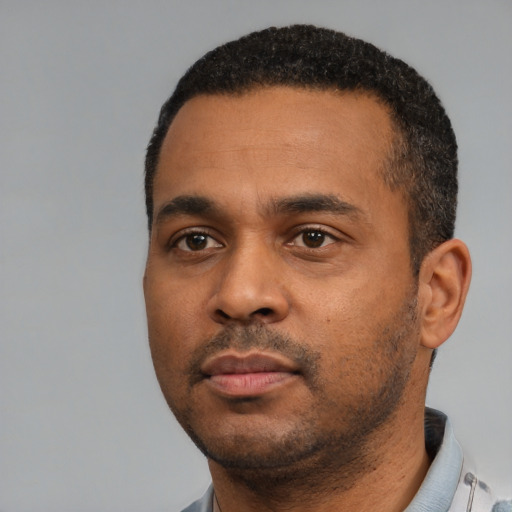 Neutral black young-adult male with short  black hair and brown eyes