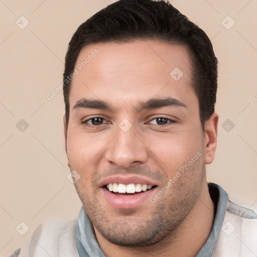 Joyful white young-adult male with short  black hair and brown eyes