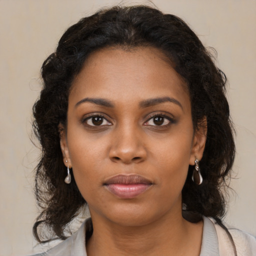 Neutral black young-adult female with medium  brown hair and brown eyes