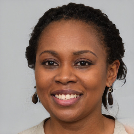 Joyful black young-adult female with short  black hair and brown eyes