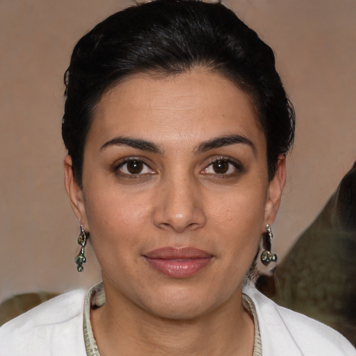 Joyful latino young-adult female with short  brown hair and brown eyes