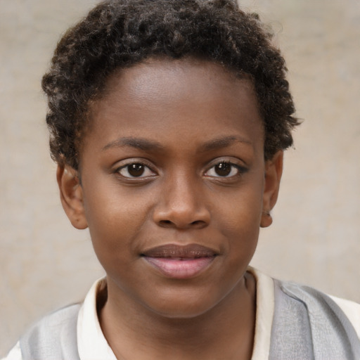Joyful black child female with short  brown hair and brown eyes