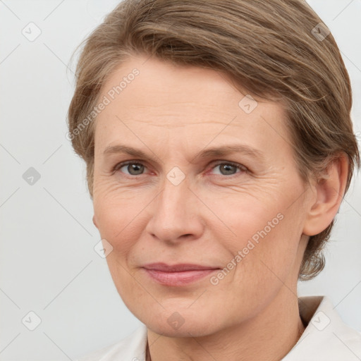 Joyful white adult female with medium  brown hair and grey eyes