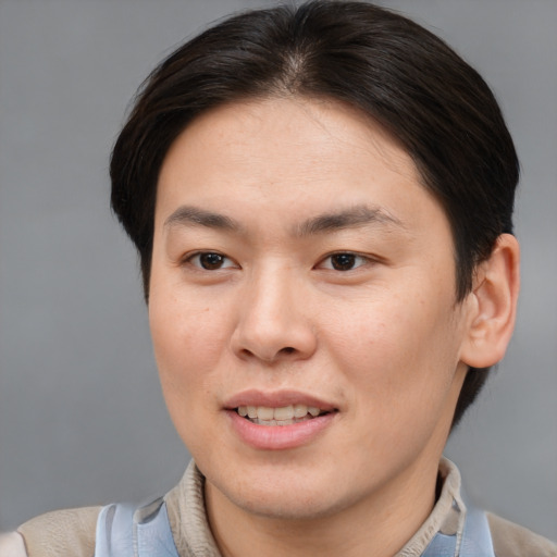 Joyful asian young-adult male with short  brown hair and brown eyes