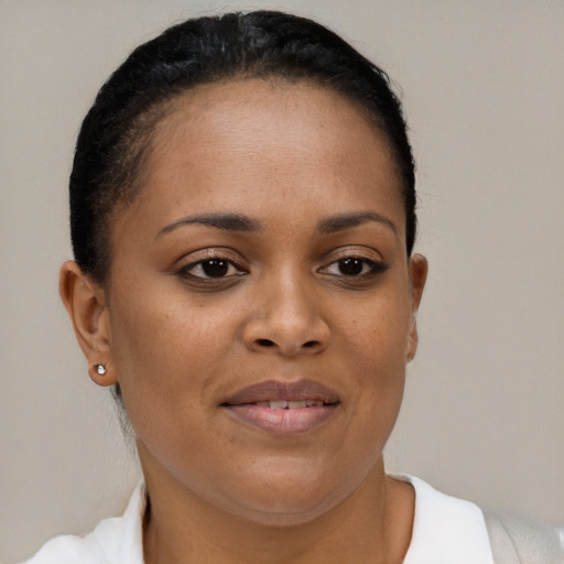Joyful black young-adult female with short  brown hair and brown eyes