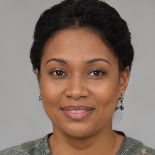Joyful black adult female with short  brown hair and brown eyes