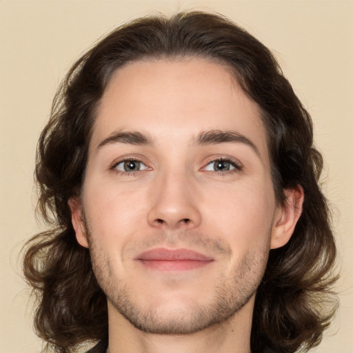 Joyful white young-adult male with medium  brown hair and brown eyes