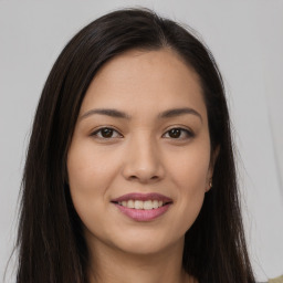 Joyful asian young-adult female with long  brown hair and brown eyes