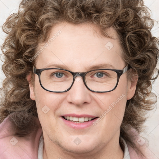 Joyful white adult female with medium  brown hair and blue eyes