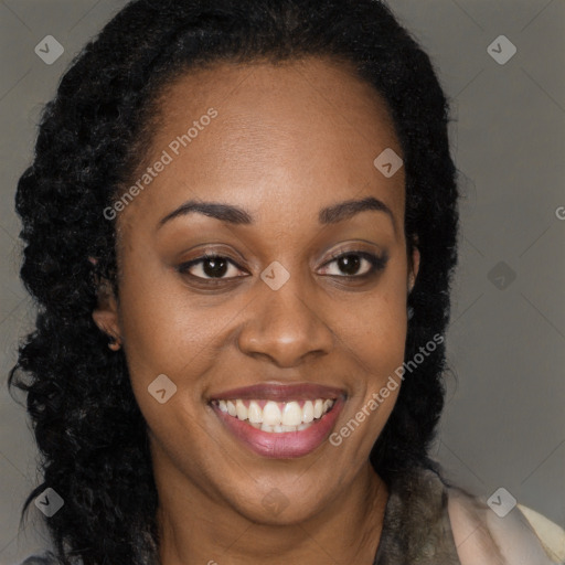 Joyful black young-adult female with long  brown hair and brown eyes