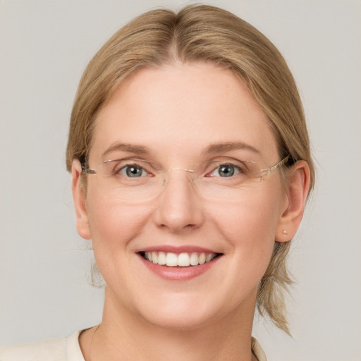 Joyful white young-adult female with medium  brown hair and blue eyes