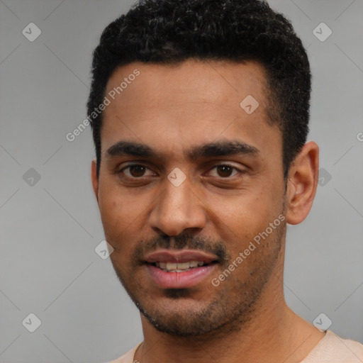 Joyful black young-adult male with short  black hair and brown eyes