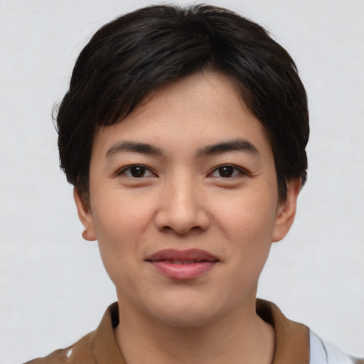 Joyful asian young-adult female with short  black hair and brown eyes