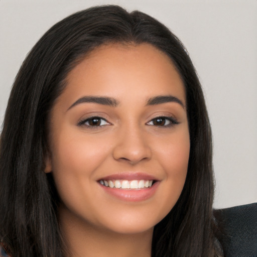 Joyful latino young-adult female with long  brown hair and brown eyes