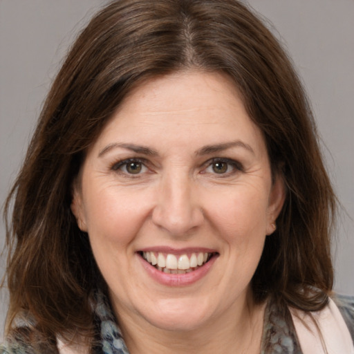 Joyful white adult female with medium  brown hair and brown eyes