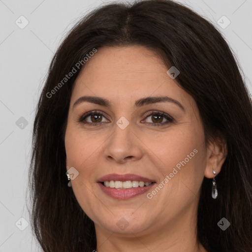 Joyful white adult female with long  brown hair and brown eyes