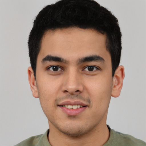 Joyful latino young-adult male with short  brown hair and brown eyes