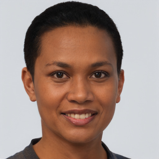 Joyful black young-adult female with short  brown hair and brown eyes