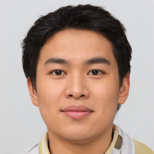 Joyful asian young-adult male with short  brown hair and brown eyes