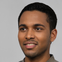 Joyful black young-adult male with short  black hair and brown eyes