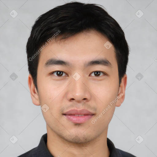 Joyful asian young-adult male with short  black hair and brown eyes