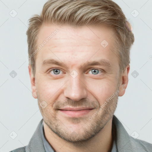 Joyful white adult male with short  brown hair and blue eyes