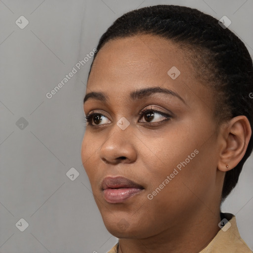 Joyful black young-adult female with short  black hair and brown eyes