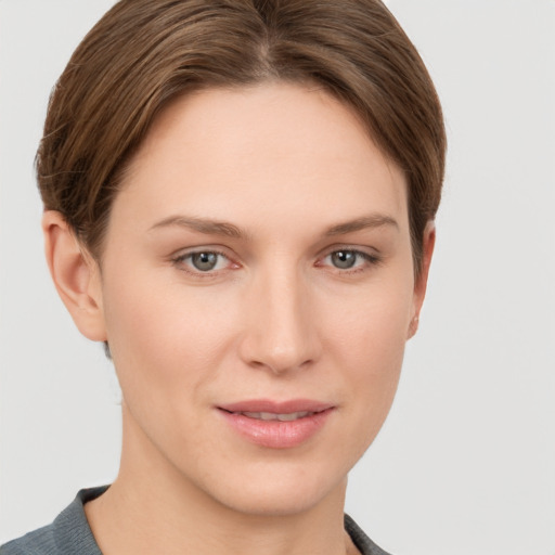 Joyful white young-adult female with short  brown hair and grey eyes