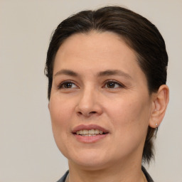 Joyful white adult female with medium  brown hair and brown eyes