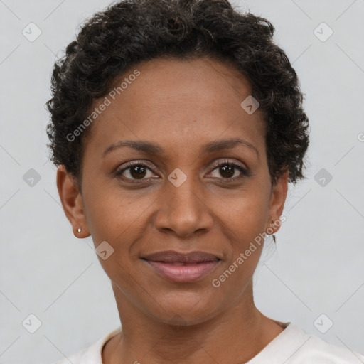 Joyful black adult female with short  brown hair and brown eyes