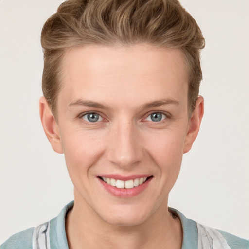 Joyful white young-adult female with short  brown hair and blue eyes