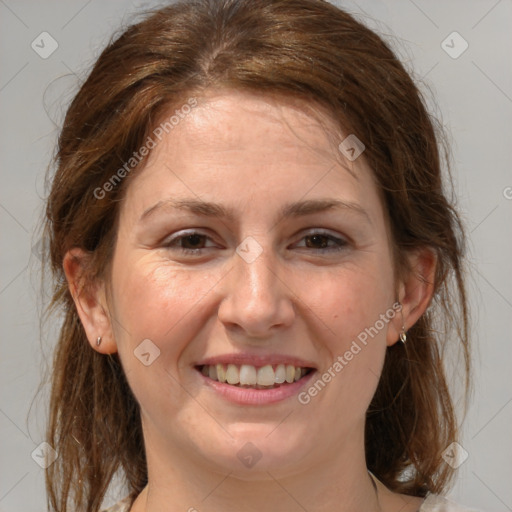 Joyful white adult female with medium  brown hair and grey eyes