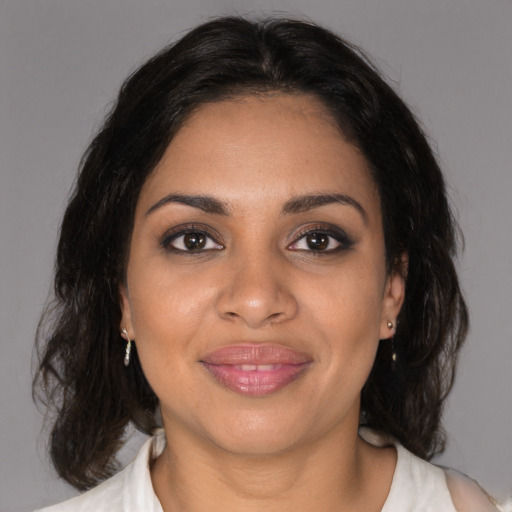 Joyful black young-adult female with medium  brown hair and brown eyes