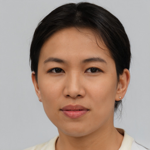 Joyful asian young-adult female with short  black hair and brown eyes