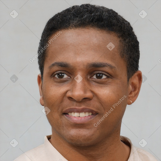 Joyful black young-adult male with short  black hair and brown eyes