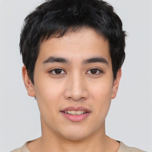 Joyful asian young-adult male with short  black hair and brown eyes