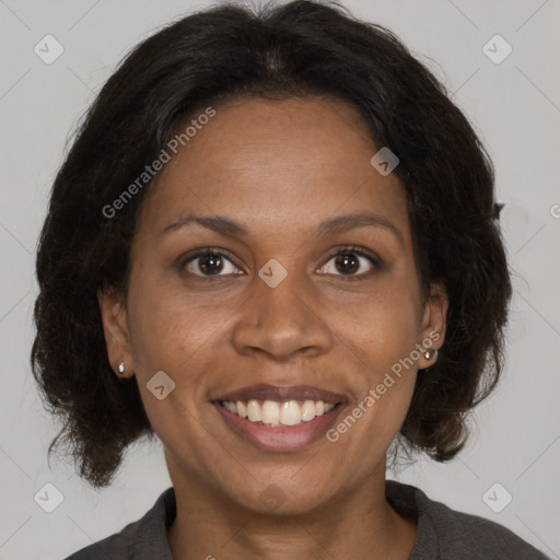 Joyful black adult female with medium  brown hair and brown eyes