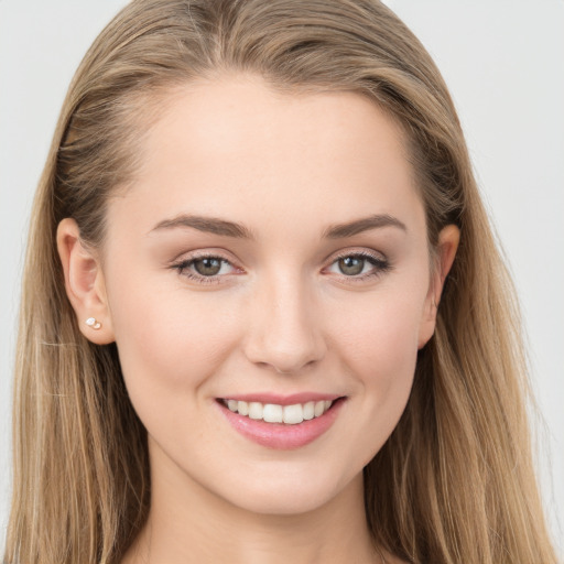 Joyful white young-adult female with long  brown hair and grey eyes