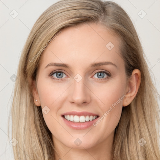 Joyful white young-adult female with long  brown hair and blue eyes