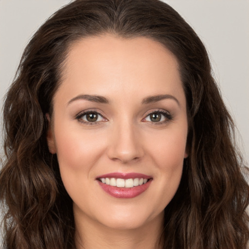 Joyful white young-adult female with long  brown hair and brown eyes