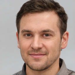 Joyful white adult male with short  brown hair and brown eyes