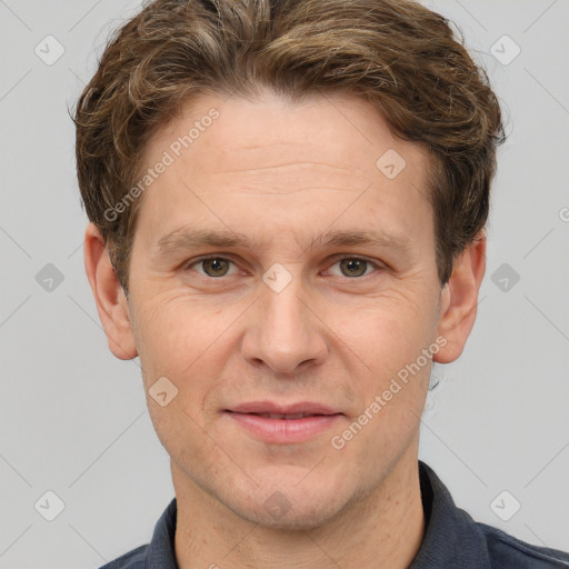 Joyful white adult male with short  brown hair and grey eyes