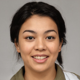 Joyful asian young-adult female with medium  black hair and brown eyes