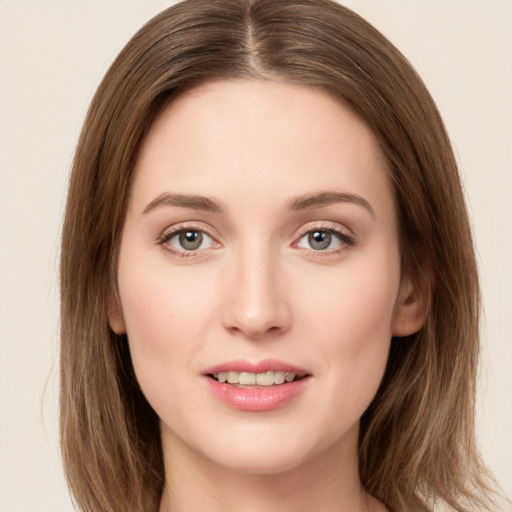 Joyful white young-adult female with long  brown hair and green eyes