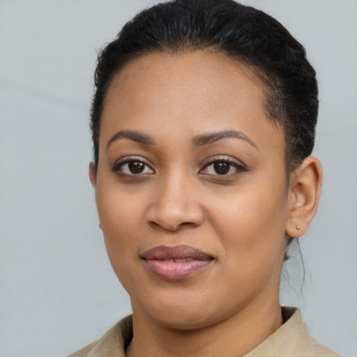 Joyful black young-adult female with short  brown hair and brown eyes