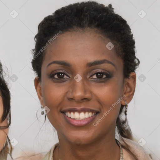 Joyful black young-adult female with long  brown hair and brown eyes