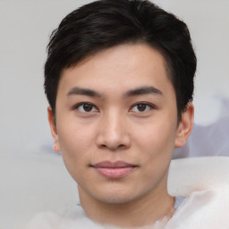 Joyful asian young-adult male with short  black hair and brown eyes
