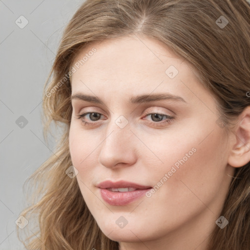 Joyful white young-adult female with long  brown hair and blue eyes