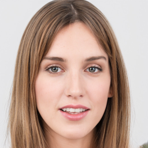 Joyful white young-adult female with long  brown hair and green eyes