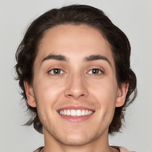 Joyful white young-adult male with medium  brown hair and brown eyes